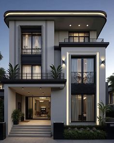 a large white house with lots of windows and balconies on the second floor