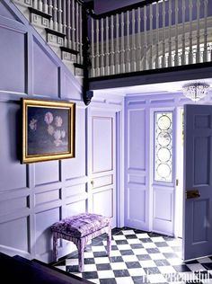 a purple room with a checkered floor and chandelier