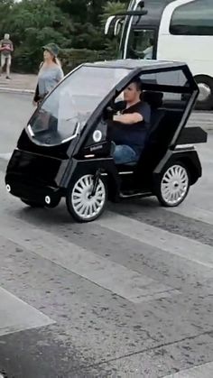 a man driving an electric car on the street