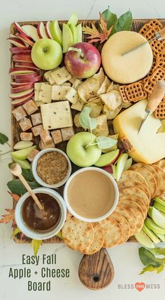 an apple cheese board with apples, crackers and dips on it for dipping