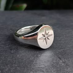 A 925 sterling silver signet ring with a north star engraving A perfect simple silver signet ring with a nautical and astronomy theme. Sustainably hand crafted in the UK from 100% recycled silver. Signet Engagement Rings, Ring Sketch, Mens Sterling Silver Jewelry, Color Knowledge, Coin Rings, Mens Rings Fashion, Signet Ring Men, Sterling Silver Mens Rings, Silver Signet Ring