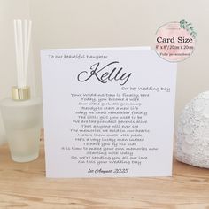 a card that is on top of a table next to a vase and candle holder