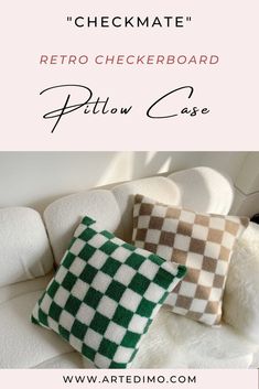 two green and white checkered pillows sitting on top of a white couch next to each other