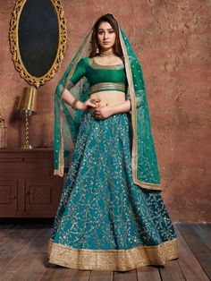 Look super gorgeous wearing this teal green art silk bridal indian lehenga for woman decked with dazzling sequins work, zari embroidered enhanced by dori work and broad heavy gota lace border.  Accompanied by a bottle green color art silk heavily zari embroidered laced choli and teal green net embellished dupatta in similar lace borders. It can be customized up to 42 inches.    Price:$51.20 Bridal Chaniya Choli, Indian Designer Lehenga, Lehenga Choli Designer, Wedding Bollywood, Ghaghra Choli, Designer Bridal Lehenga Choli, Lehenga Choli Designs, Printed Lehenga, Sabyasachi Lehenga