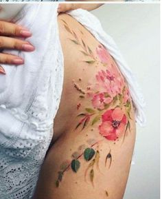 a woman's thigh with flowers painted on it