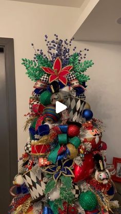 a christmas tree decorated with ornaments and ribbons