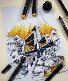 some pens are laying on top of a drawing