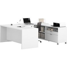 an office desk with two laptops on it and one open file cabinet next to it