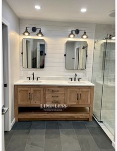 a bathroom with two sinks and mirrors on the wall next to a walk in shower