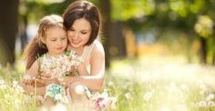 a mother and daughter hugging each other in the grass with an inspirational quote above them