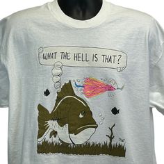 What the Hell Is That? Funny Fishing Lure Vintage 90s T Shirt X-Large Fisherman Bass King 2 Sonic Bait Mens White Fruit of the Loom Single Stitch Graphic Tee CONDITION: Has minor image cracking. Tag is a XXL but I feel it measures more similar to a modern X-Large. Check measurements to ensure fit. See photos. SIZE AND MEASUREMENTS: Mens/Unisex XL X-Large Width 24" - Underarm to underarm Length 30.5" - Measure from top of shoulder at the edge of collar to the bottom of the shirt Casual Crew Neck Shirt For Fishing, Casual Crew Neck Fishing T-shirt, Casual Pre-shrunk T-shirt For Fishing, Casual Crew Neck T-shirt For Fishing, Summer Fishing T-shirt With Crew Neck, Summer Crew Neck T-shirt For Fishing, Crew Neck T-shirt For Summer Fishing, Graphic Print Shirt For Fishing In Summer, White Graphic Print Tops For Fishing