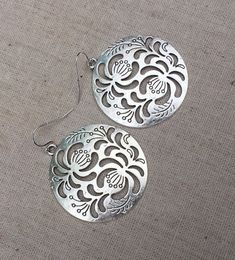 "These are so unbelievably beautiful and stylish! Big silver boho floral disc earrings. They have incredible detail and design. The perfect everyday statement earrings. These are simply gorgeous earrings. Made from allergy free plated silver. The earrings measure 1 5/8\" long by 1 5/8\" long. They hang from simple silver ear wire hooks. Overall drop length is 1 3/4\". I have a matching necklace in my shop if you would like the whole set. Here is a direct link https://etsy.me/3d1P92f Thanks for s Bohemian Flower Hoop Earrings With Ear Wire, Bohemian Flower-shaped Pierced Earrings, Bohemian Flower-shaped Hoop Earrings, Bohemian Flower Hoop Earrings, Flower Shaped Festival Jewelry With Ear Wire, Flower-shaped Matching Earrings For Festivals, Bohemian Sterling Silver Pierced Flower Earrings, Flower-shaped Jewelry With Matching Earrings For Festivals, Festival Flower Shaped Jewelry With Ear Wire