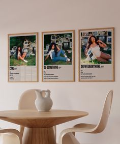 two posters are hanging on the wall above a dining room table with chairs and a vase