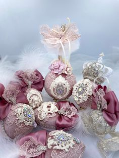 some pink and white ornaments are sitting on the furnishing with feathers around them