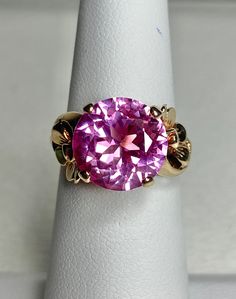 This ring is beautiful! The ring features a nice quality synthetic pink spinel that is 11mm in diameter. The ring is in nice condition for its age, but will show signs of natural wear (see photos). The ring is solid 10k yellow gold and weighs a hefty 4.5g Spinel Ring, Pink Spinel, Gold Floral, 10k Gold, Rings Statement, Portland, Statement Rings, Beautiful Jewelry, Jewelry Rings