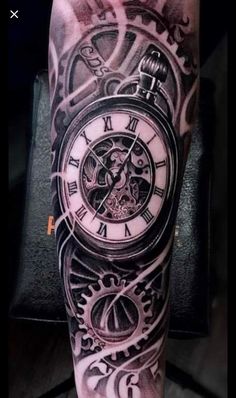 a man's arm with a clock tattoo on it