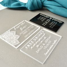 the business card is clear and has black ink on it, along with a blue scarf