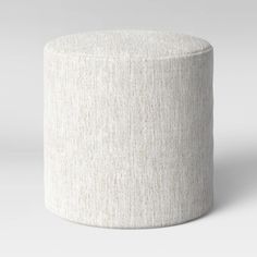 an upholstered stool with white fabric