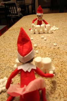 an elf is sitting on the counter next to marshmallows