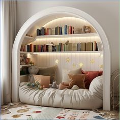 a white bed with lots of pillows and bookshelves in the corner next to it