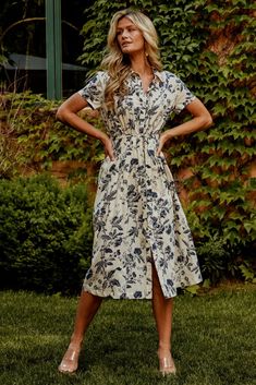 Elevate your wardrobe with our stunning midi dress adorned with a beautiful floral pattern. The notched neckline and functional buttons down the front add a touch of sophistication and versatility to this timeless piece. Notched Neckline, Waist Sash, Navy Print, Dress Beige, Beige Background, Navy Floral, Timeless Pieces, A Line Dress, Floral Pattern