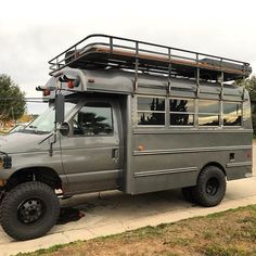 a large gray truck parked on the side of a road