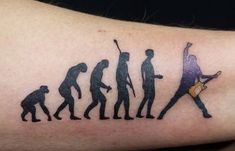 a man with a guitar tattoo on his arm that has the silhouettes of people playing instruments