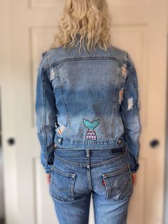 Women's Denim Jean Jacket.  Size S.  Buttons all the way down as well as two additional buttons for the pockets on the front and another two buttons for fastening in the back. Mermaid Tail on the back of the jacket to truly make this upcycled Jean jacket a one of a kind . Mermaids Tail, Upcycle Jeans, Denim Jean Jacket, Women Denim Jeans, Mermaid Tail, Denim Jean, Sea Life, Denim Women, Jean Jacket