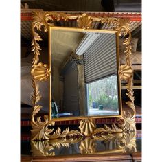 a mirror sitting on top of a wooden table