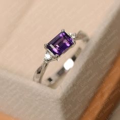 Emerald Cut Amethyst Ring For Formal Occasions, Elegant Emerald Cut Amethyst Promise Ring, Elegant Emerald Cut Amethyst Birthstone Ring, Elegant Emerald-cut Amethyst Birthstone Ring, Emerald Cut Amethyst Ring In White Gold, Classic White Gold Emerald Cut Amethyst Ring, Purple Emerald-cut Birthstone Ring For Anniversary, Classic Purple Emerald Cut Rings, Elegant Solitaire Amethyst Ring With Emerald Cut