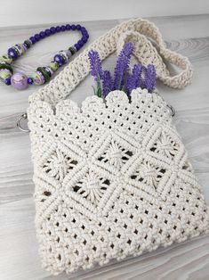 a crocheted purse with flowers in it