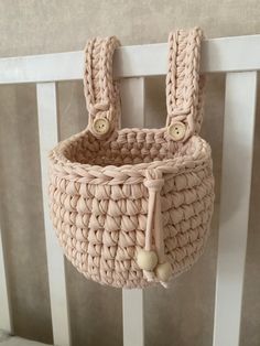 a crocheted basket hanging on the wall