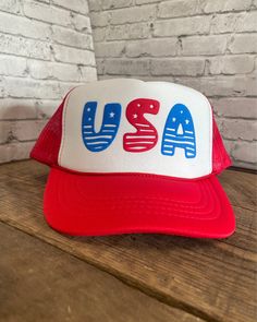 Custom USA Puff Print Youth Hat - Foam Hat with adjustable snapback Do your kids need gear for a USA celebration? We have you covered! This is the ultimate hat to sport during any USA occasion. With eight design choices to choose from, there is sure to be a hat for everyone in your kid group. The designs will be in the puff colors as shown (blue and red) in the "Design Options" pictures, but you can customize your hat by picking a hat color.  **If you would like a design to have different wording, or the colors to be different, please message us and we will try our best to accommodate you! ** Listing Reference: OTTO Cap 5 Panel High Crown Polyester Foam Front Mesh Back Trucker Hat This hat is 100% polyester and has a 5 panel seamless foam front panel with a lining matching braid.  Plastic Fun Red Snapback Trucker Hat, Novelty Red Trucker Hat, Red Adjustable Themed Hat, Adjustable White Hat For 4th Of July, Novelty Red Cap Hat, Fun Red Adjustable Trucker Hat, Fun Red Snapback Baseball Cap, Red Adjustable Fun Trucker Hat, Fun Red Snapback Hat With Curved Brim