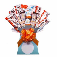 an assortment of chocolates in a gift box with orange ribbon and bow on white background