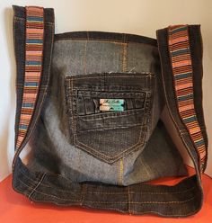 an old pair of jeans is sitting on top of a table with a purse in it