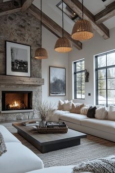 a living room filled with furniture and a fire place in the middle of two windows