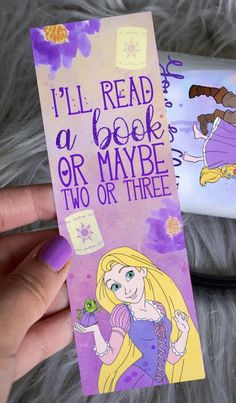 a hand holding a bookmark that says i'll read a book or maybe two or three