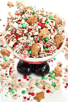 a white bowl filled with christmas cheerios on top of a table