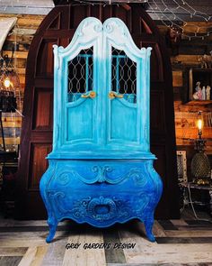 an old blue cabinet with glass doors