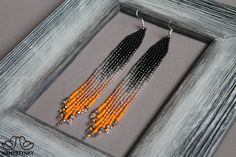 These silver orange beaded earrings with crystals are made of high-quality Czech beads and strong synthetic thread. They are elegant, fashionable, and highly versatile, suitable for everyday wear.Features: Sterling silver componentsColor: black, silver, orange.This item is currently in stock.You must be completely satisfied. If you find merchandise unsatisfactory for any reason, return it within 10 days and your money will be refunded without questions.More beaded earrings http://etsy.me/2ycItdb Earring Displays, Turquoise Bead Earrings, Earrings With Crystals, Ombre Earrings, Earring Dangle, Long Fringe, Earrings Long, Seed Bead Earrings, Czech Beads