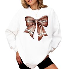 Step up your football season style with our Football Coquette Bow Sweatshirt! This cozy pullover, available in White, Red, or Gray, features a chic bow design that resembles a football, making it the perfect choice for football cheerleaders, fans, and moms alike. Whether you're cheering on the sidelines or staying warm during a chilly game, this sweatshirt combines comfort with a trendy look that's sure to turn heads. Why You'll Love It: This sweatshirt isn't just about staying warm--it's about making a stylish statement! The football Coquette Bow design adds a feminine twist to your game day outfit, making it a must-have for any football mom, cheerleader, or fan. Plus, its soft and comfortable fabric ensures you'll stay cozy whether you're at the game or out and about. Care Instructions: White Long Sleeve Sweatshirt With School Spirit, White Long Sleeve Sweater For Game Day, White Sweatshirt For Game Day In Winter, White Winter Game Day Sweatshirt, White Crew Neck Sweater For Game Day, White Tops With Team Spirit For Fall, White Tops For Fall With Team Spirit Style, Casual Tops For Cheerleading In Fall, Fall Cheerleading Crew Neck Sweatshirt