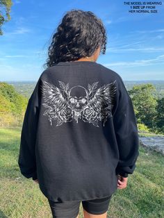 This goth sweatshirt is a great addition to your gothic clothes collection! It's a skull, skeleton sweatshirt with Y2k and dark angel core vibes. This can even work if you're going for an emo, grunge or punk clothing style! * Graphic is a high quality digital print which is durable and long lasting! * 50% cotton / 50% poly fabric blend * Wash and dry normally (on cool for best results) S I Z I N G * This style is unisex & fits like a men's sweatshirt. It fits slightly smaller than true to size. Oversized Punk Halloween Sweatshirt, Oversized Punk Sweatshirt For Halloween, Oversized Long Sleeve Sweatshirt With Skull Print, Oversized Long-sleeve Sweatshirt With Skull Print, Emo Long Sleeve Sweatshirt For Streetwear, Black Long Sleeve Emo Sweatshirt, Black Grunge Sweatshirt For Concert, Black Gothic Sweatshirt For Streetwear, Alternative Skull Print Sweatshirt For Fall