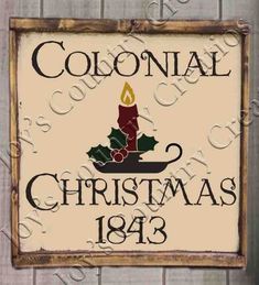 a sign that says colonial christmas, with a candle and holly wreath on the front