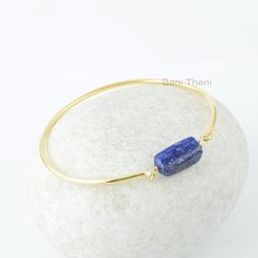 Lapis Lazuli Bangle, Lapis Lazuli 8x18mm Nugget Bead Gemstone Bangle, Silver Bangle, 18k Gold Plated Bangle, Lapis Bracelets For Women Item Code: BJ3043 Metal: 925 Sterling Silver Plating: 18k Gold Plated Stone Detail:- Lapis Lazuli 8x18mm Nugget Bead * Please note that there will be slight variations in stone texture and color shades in the actual product that you receive. Stone quality or grade will be same. * All our jewelry is Micron Plated which is higher quality as compared to Standard Pla Gold Lapis Lazuli Bracelet With Gemstone, Gold Bracelets With Lapis Lazuli And Natural Stones, Gold Lapis Lazuli Gemstone Bracelet, Gold Lapis Lazuli Bracelets For Gift, Gold Bangle With Gemstone Beads, Rectangular Gemstone Beads Gold Jewelry, Gold Rectangular Gemstone Beads Jewelry, Gold Rectangular Jewelry With Gemstone Beads, Rectangular Gold Jewelry With Gemstone Beads