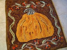 a brown rug with a yellow pumpkin on it