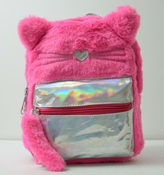 a pink backpack with a cat's face on the front, and a shiny silver bag behind it