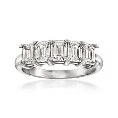 a three stone diamond ring set in 18k white gold with baguets and diamonds