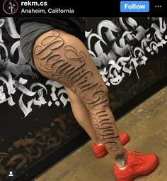 a person with tattoos on their legs and leggings that say, i love california