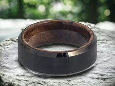 a wooden ring sitting on top of a rock