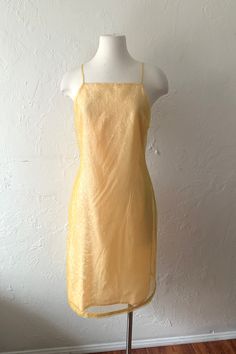 Lovin this 90s or 00s Y2K dress by Isabel Ardee. So so cute and special.. buttercup yellow sheer kind of iridescent crinkly shiny texture sheath dress with spaghetti straps. Zips up the back, lined and nice ribbon detail at hem.   Size 6, bust 36" waist 31" hip 39" length 41" Would be super cute hemmed mini mini too..  *a bit on me I'm usually an xs 0-ish so I'm holding a couple inches in at the back for front photo.. the mannequin is bust 34" waist 24" hip 34" so best on a small-ish / medium 4/6 Yellow Fitted Slip Dress For Evening, Yellow Summer Slip Dress For Evening, Fitted Yellow Slip Dress For Evening, Yellow Slip Dress For Summer Evening, Vintage Spring Slip Dress For Party, Vintage Slip Dress For Spring Party, Spring Vintage Slip Dress For Party, Yellow Fitted Midi Slip Dress, Yellow Fitted Slip Dress For Party